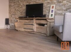 Rustiek houten tv-meubel in de woonkamer met licht eikenhouten vloer. Interieurontwerp. door Van Weenen Bouwbedrijf